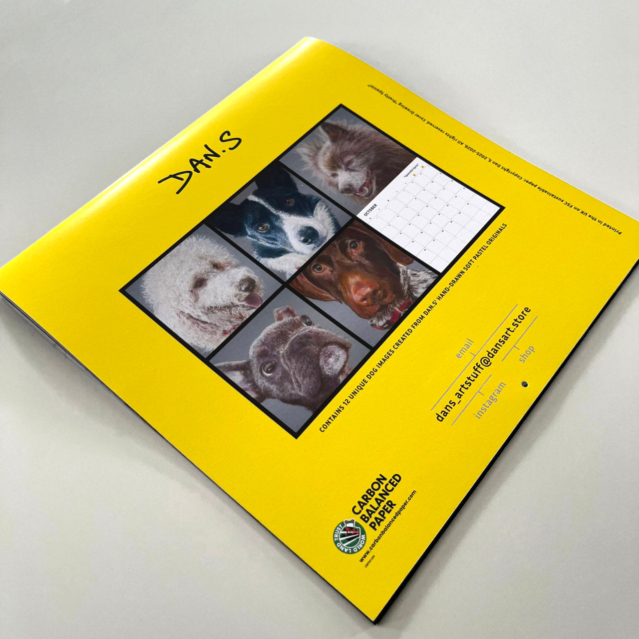 Back page of a yellow calendar with dog images
