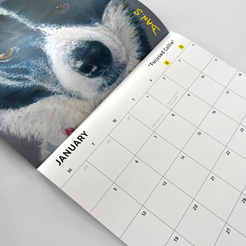 Calendar open to January with a close-up of a dog's face on the left page