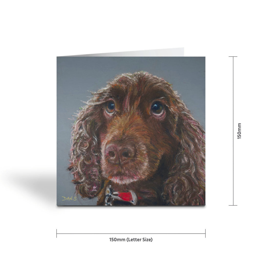 Picture of a card with a brown cocker spaniel's face with a grey background 
