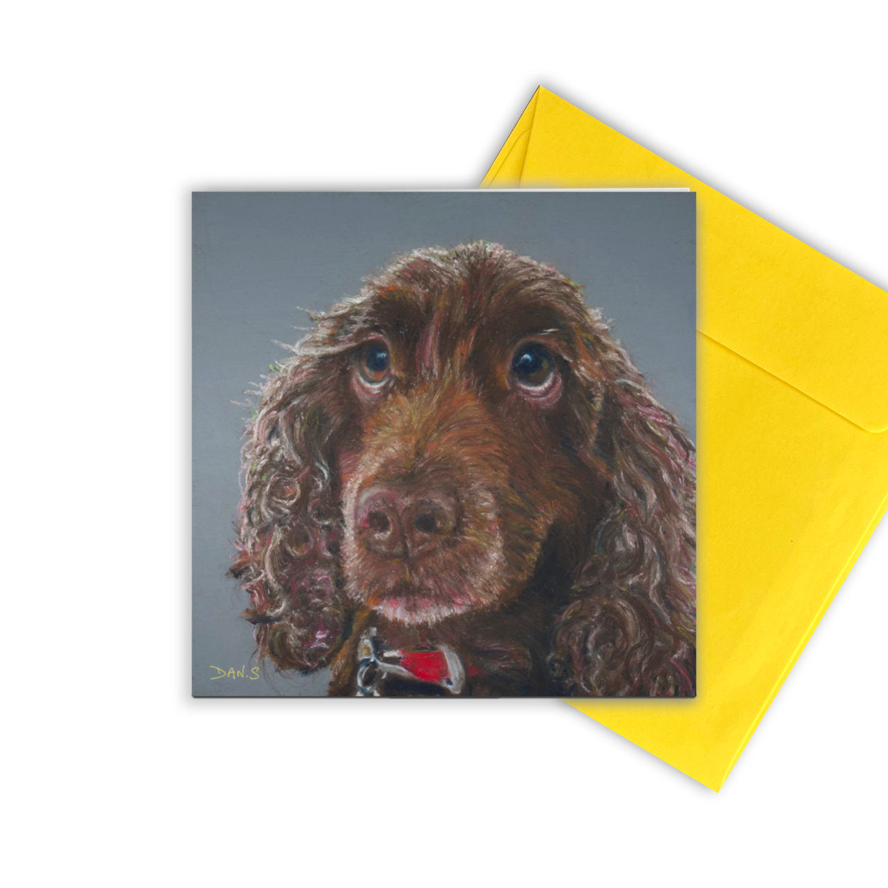 Picture of a card with a brown cocker spaniel's face with yellow envelope