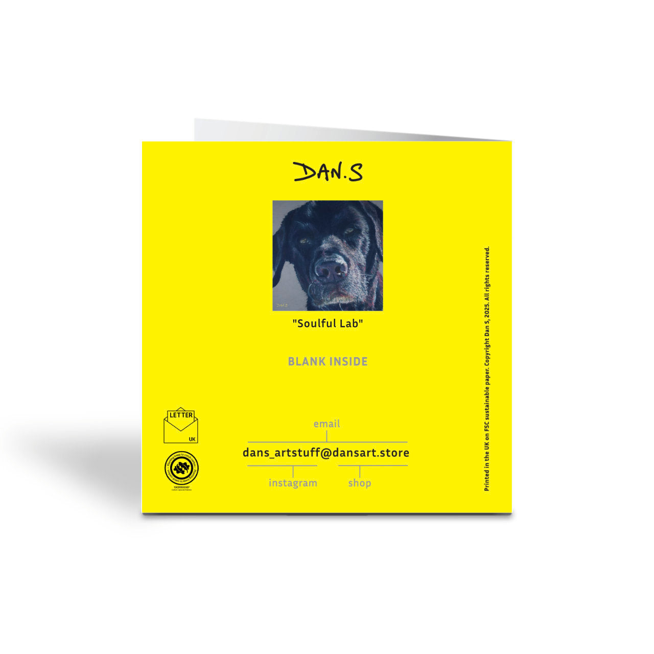 Picture of the back of a greetings card featuring a black Labrador
