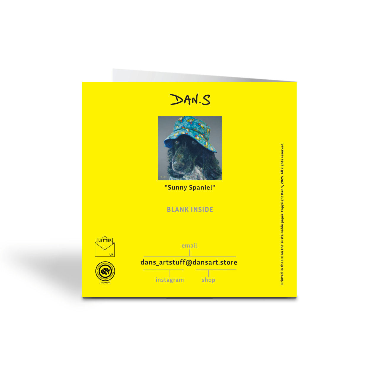 Back of yellow card with picture of a cocker spaniel wearing a colourful bucket hat