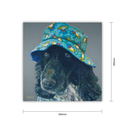 Picture of a cocker spaniel wearing a colourful bucket hat on a grey background